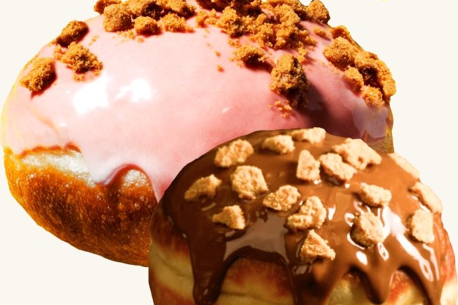 A pink-glazed doughnut and a chocolate-glazed doughnut from Sesame, both topped with crumble